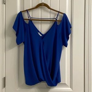 Strappy off the shoulder shirt.